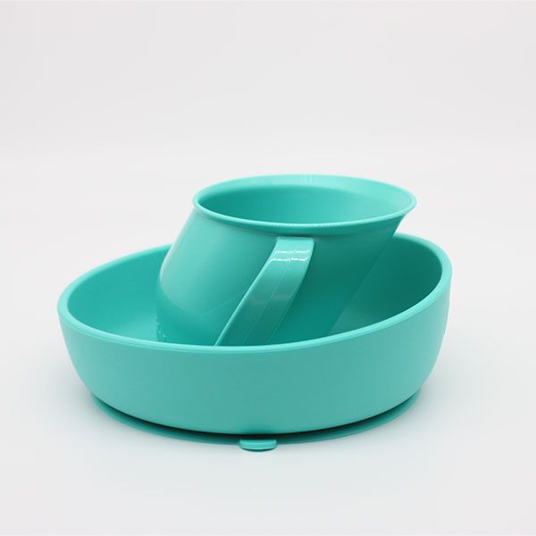 Plato y taza de la marca Doidy de color turquesa